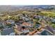 Lush residential neighborhood with manicured lawns, mature trees, and sparkling pools near a golf course and mountainous backdrop at 395 Suzanne Peak Ct, Henderson, NV 89012