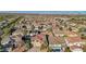 Overview of a neighborhood featuring well-maintained homes with manicured lawns and mature trees with mountain views in the distance at 395 Suzanne Peak Ct, Henderson, NV 89012