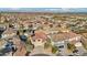Bustling residential neighborhood featuring a mix of homes with tile roofs and mature trees against a scenic mountain backdrop at 395 Suzanne Peak Ct, Henderson, NV 89012