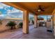 Inviting covered patio with an outdoor kitchen, grill, and lush landscaping at 395 Suzanne Peak Ct, Henderson, NV 89012