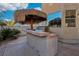 Outdoor kitchen with palapa and built in stainless steel grill is perfect for entertaining guests at 395 Suzanne Peak Ct, Henderson, NV 89012