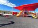 A playground offers slides, climbing structures, and a seesaw for to enjoy at 395 Suzanne Peak Ct, Henderson, NV 89012
