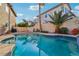 Refreshing pool featuring rock accents and lush landscaping creates a serene backyard retreat at 395 Suzanne Peak Ct, Henderson, NV 89012