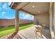 Covered patio with artificial turf and seating area at 2261 Cold Canyon Ave, North Las Vegas, NV 89086