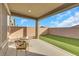 Covered patio, artificial turf, and small table with chairs at 2261 Cold Canyon Ave, North Las Vegas, NV 89086