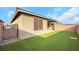 Private backyard with artificial turf and covered patio at 2261 Cold Canyon Ave, North Las Vegas, NV 89086
