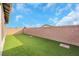 Landscaped backyard with artificial turf and block wall at 2261 Cold Canyon Ave, North Las Vegas, NV 89086