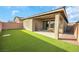 Home exterior showcasing a covered patio and grassy backyard at 2261 Cold Canyon Ave, North Las Vegas, NV 89086