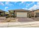 Single-story home with a two-car garage and landscaped front yard at 2261 Cold Canyon Ave, North Las Vegas, NV 89086