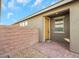 Inviting front entry with a yellow door and brick walkway at 2261 Cold Canyon Ave, North Las Vegas, NV 89086