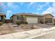 Single-story home with a two-car garage and landscaped front yard at 2261 Cold Canyon Ave, North Las Vegas, NV 89086