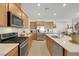 Modern kitchen with stainless steel appliances and light wood cabinets at 2261 Cold Canyon Ave, North Las Vegas, NV 89086