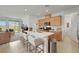 Open concept kitchen with island, stainless steel appliances, and access to laundry at 2261 Cold Canyon Ave, North Las Vegas, NV 89086