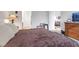 Main bedroom with large bed, dresser, and view into living room at 2261 Cold Canyon Ave, North Las Vegas, NV 89086