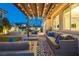 Inviting covered back patio with comfortable seating and string lights, perfect for outdoor relaxation and entertaining at 3372 Dalmore St, Henderson, NV 89044