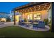 Landscaped backyard featuring a patio with string lights, patio seating, and lawn at 3372 Dalmore St, Henderson, NV 89044
