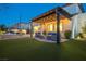 Landscaped backyard features string lights, outdoor seating, and a hot tub at 3372 Dalmore St, Henderson, NV 89044