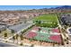 Aerial view of community basketball courts, surrounded by green spaces and walking paths at 3372 Dalmore St, Henderson, NV 89044