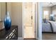 View from a bedroom doorway with a mirrored cabinet and partial view of a stylish and accessible bathroom at 3372 Dalmore St, Henderson, NV 89044