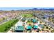 Overhead view of a neighborhood park with a playground, picnic shelters, and open green spaces at 3372 Dalmore St, Henderson, NV 89044