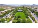 Aerial view of the community park, featuring a green lawn, walking paths, and mature trees at 3372 Dalmore St, Henderson, NV 89044