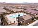 Aerial view of the community pool area with lounge chairs and well-maintained landscaping at 3372 Dalmore St, Henderson, NV 89044