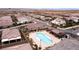 High aerial view of the community pool area, highlighting the pool, lounge seating, and surrounding neighborhood at 3372 Dalmore St, Henderson, NV 89044