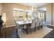 Bright dining room with a wooden table and comfortable seating, complemented by large windows and modern lighting at 3372 Dalmore St, Henderson, NV 89044