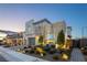 Beautiful two-story home with a stone facade and landscaped front yard at dusk at 3372 Dalmore St, Henderson, NV 89044