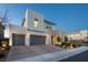 Exterior view of a modern two-story home with a three-car garage, manicured landscaping and stone accents at 3372 Dalmore St, Henderson, NV 89044