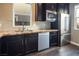Modern kitchen with stainless steel appliances, granite countertops, and dark wood cabinets at 3372 Dalmore St, Henderson, NV 89044
