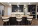 Gourmet kitchen with dark wood cabinets, granite countertops, and a large central island with barstool seating at 3372 Dalmore St, Henderson, NV 89044