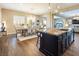 Open concept kitchen with an island, granite countertops, dark wood cabinets, and stainless steel appliances at 3372 Dalmore St, Henderson, NV 89044