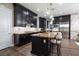 Modern kitchen featuring dark wood cabinets, stainless steel appliances, a spacious island, and stylish pendant lights at 3372 Dalmore St, Henderson, NV 89044