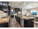 Well-equipped kitchen features dark cabinetry, granite counters, stainless appliances, and island seating at 3372 Dalmore St, Henderson, NV 89044