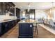 Spacious kitchen with dark wood cabinets, an island, granite countertops, and stainless steel appliances at 3372 Dalmore St, Henderson, NV 89044
