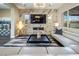 Stylish living room with a marble accent wall, modern fireplace, and plush seating arrangement at 3372 Dalmore St, Henderson, NV 89044