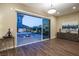 Living room showcasing wood-look floors and access to a private backyard oasis with spa and stylish furniture at 3372 Dalmore St, Henderson, NV 89044