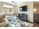 An elegant living room with a comfortable sofa, modern coffee table, and ceiling fan creating a relaxing space at 3372 Dalmore St, Henderson, NV 89044