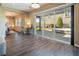 Bright living area featuring sleek tile flooring, modern lighting, and large glass doors leading to a private backyard at 3372 Dalmore St, Henderson, NV 89044
