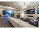 Open-concept living room with sliding glass doors to the backyard, modern fireplace and plush seating at 3372 Dalmore St, Henderson, NV 89044