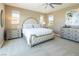 Spacious main bedroom with neutral carpeting, windows, and decorative furniture at 3372 Dalmore St, Henderson, NV 89044