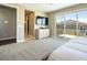 Spacious main bedroom with neutral carpeting, a TV, and a sliding glass door at 3372 Dalmore St, Henderson, NV 89044