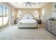 Spacious main bedroom with neutral carpeting, windows, and decorative furniture at 3372 Dalmore St, Henderson, NV 89044