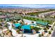 Aerial view of a vibrant community playground with sunshades, play structures, and seating areas at 3372 Dalmore St, Henderson, NV 89044