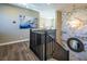 A staircase with marble accent wall and stylish chandelier, creates an inviting transition between floors at 3372 Dalmore St, Henderson, NV 89044