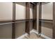 Walk-in closet with wooden built-in shelving and neutral carpeting at 3372 Dalmore St, Henderson, NV 89044