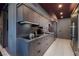 Sleek kitchenette with gray cabinetry, stainless appliances, and modern fixtures at 3726 Las Vegas Blvd # 1101, Las Vegas, NV 89158
