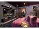Modern living room with mauve sofa, flat screen TV, and mini-kitchenette with sliding barn door at 3726 Las Vegas Blvd # 1101, Las Vegas, NV 89158