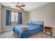 Bright bedroom with a full bed, nightstand, and ceiling fan at 4773 Sarazen Cir, Las Vegas, NV 89103
